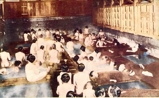 Late 1800 picture of men, women and families bathing together in a Japanese bath house